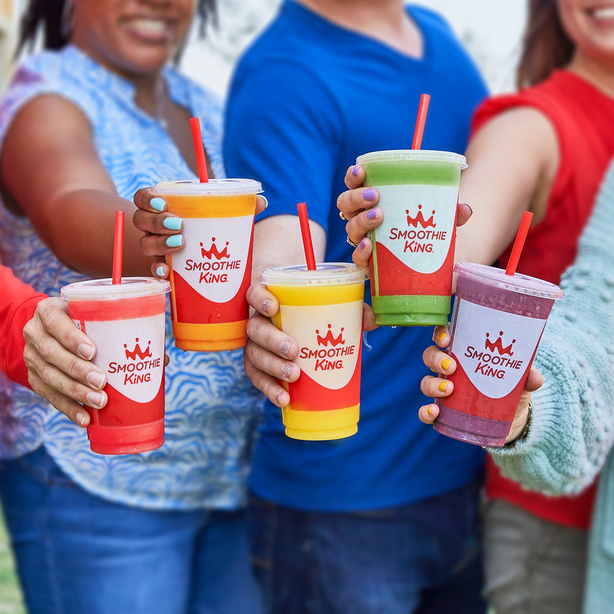 People holding Smoothie King cups